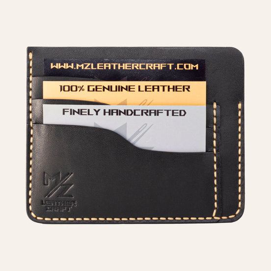 MZ Leather Craft siyah Buttero deri ters cüzdan, kartlarla dolu düz ön görünüm, 3 ön kart yuvası, sarı el dikişleri ve kabartmalı MZ logosu | The Inverse Wallet - Black Buttero Leather by MZ Leather Craft, flat front view filled with cards, featuring 3 front card slots, yellow hand-stitching, and embossed MZ logo