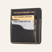 MZ Leather Craft siyah Buttero deri ters cüzdan, kartlarla dolu hafif açılı sağ profil görünümü, sarı el dikişi kalitesi ve belirgin Buttero deri dokusu | The Inverse Wallet - Black Buttero Leather by MZ Leather Craft, closed slightly angled right profile view filled with cards, highlighting yellow stitching quality and distinct Buttero leather texture