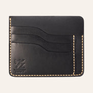 MZ Leather Craft siyah Buttero deri ters cüzdan, 3 boş kart yuvasını ve mat deri dokusunu gösteren düz ön görünüm, sarı el dikişleri ve kabartmalı MZ logosu | The Inverse Wallet - Black Buttero Leather by MZ Leather Craft, flat front view showing 3 empty card slots and matte leather texture, with yellow hand-stitching and embossed MZ logo