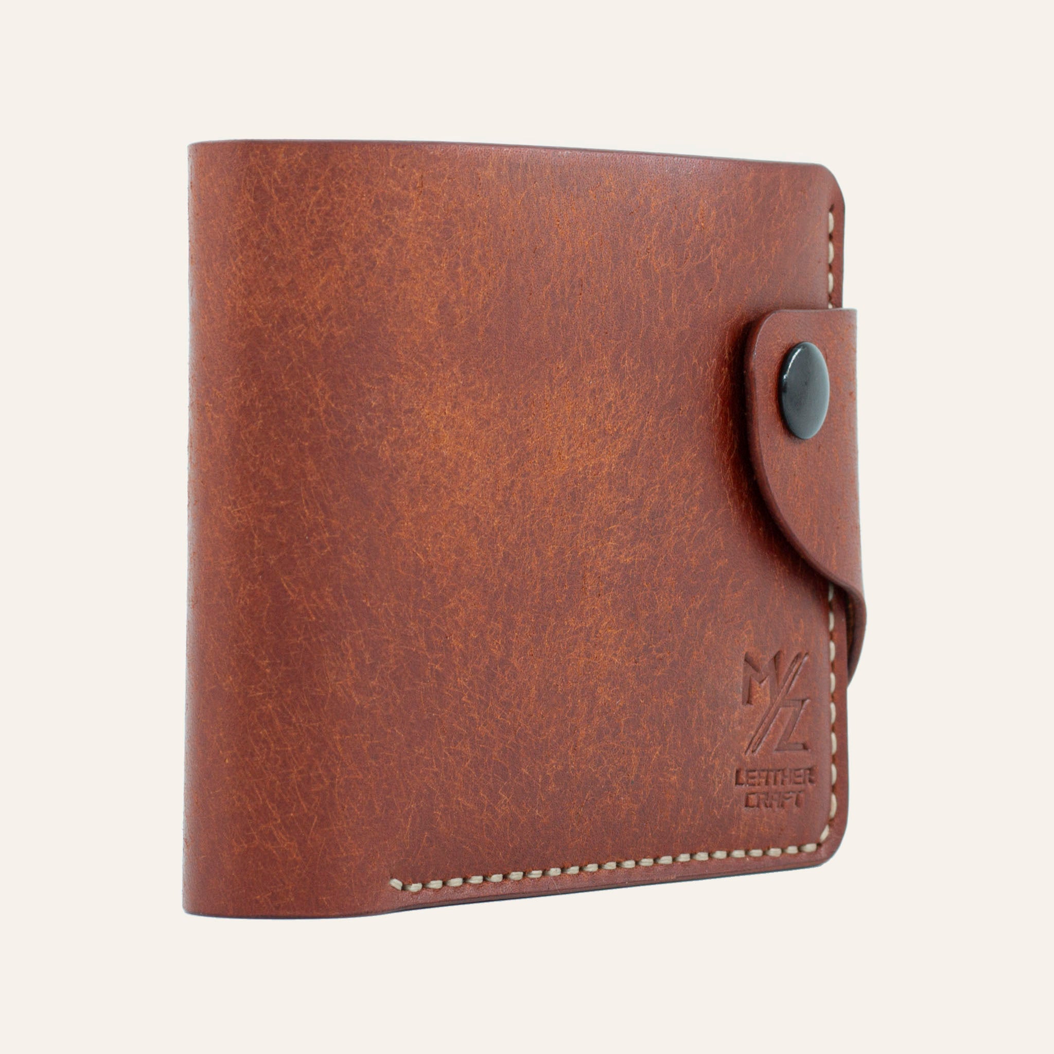 MZ Leather Craft hafif açılı kiremit Pueblo deri klasik erkek cüzdanı, kapalı duruş ve kontrast açık gri el dikişi detayları | MZ Leather Craft slightly angled siena Pueblo leather classic bifold wallet, closed position showing edge structure and light gray hand-stitching details